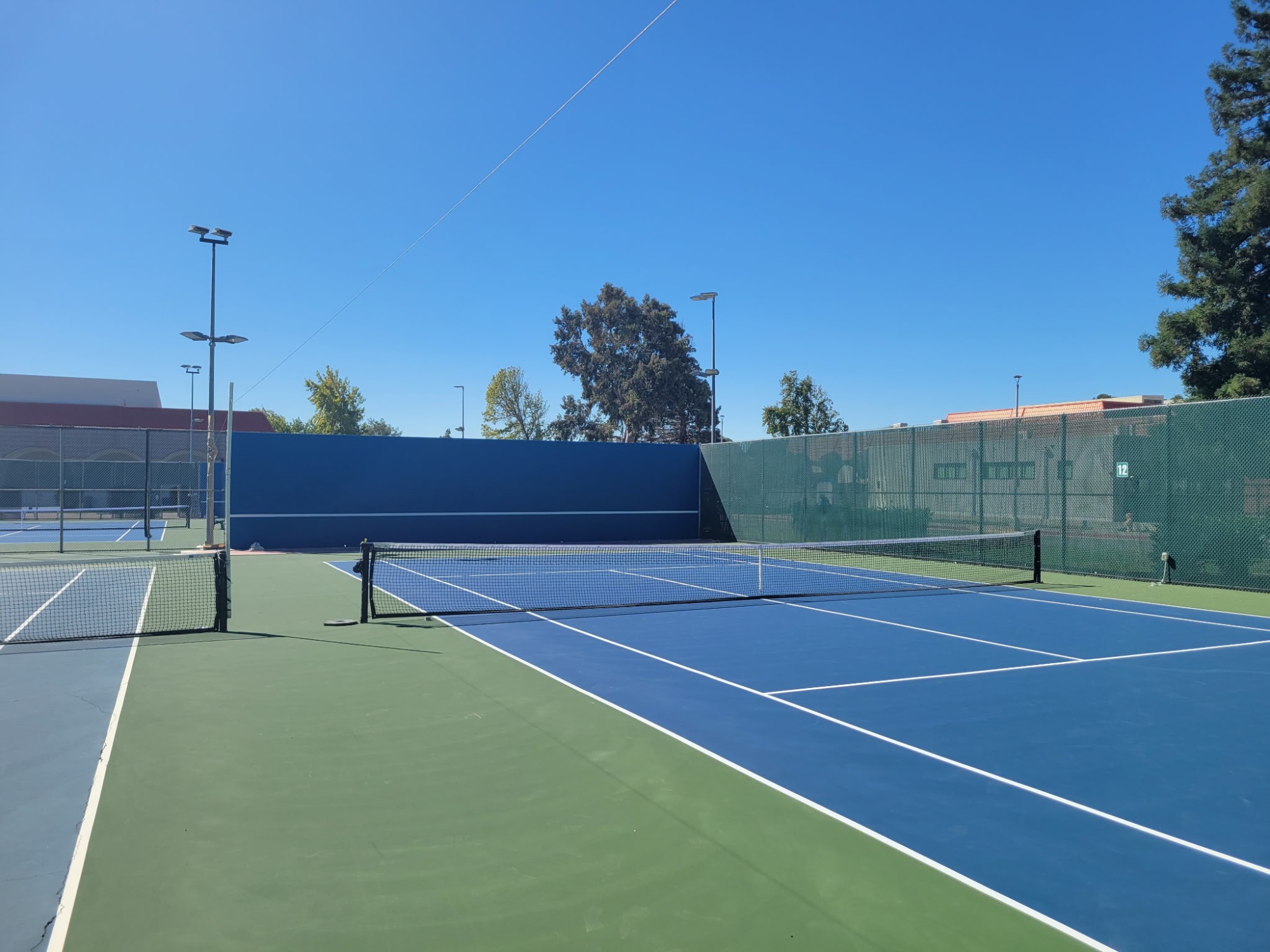 Pickleball and tennis court with fresh line striping and color coating