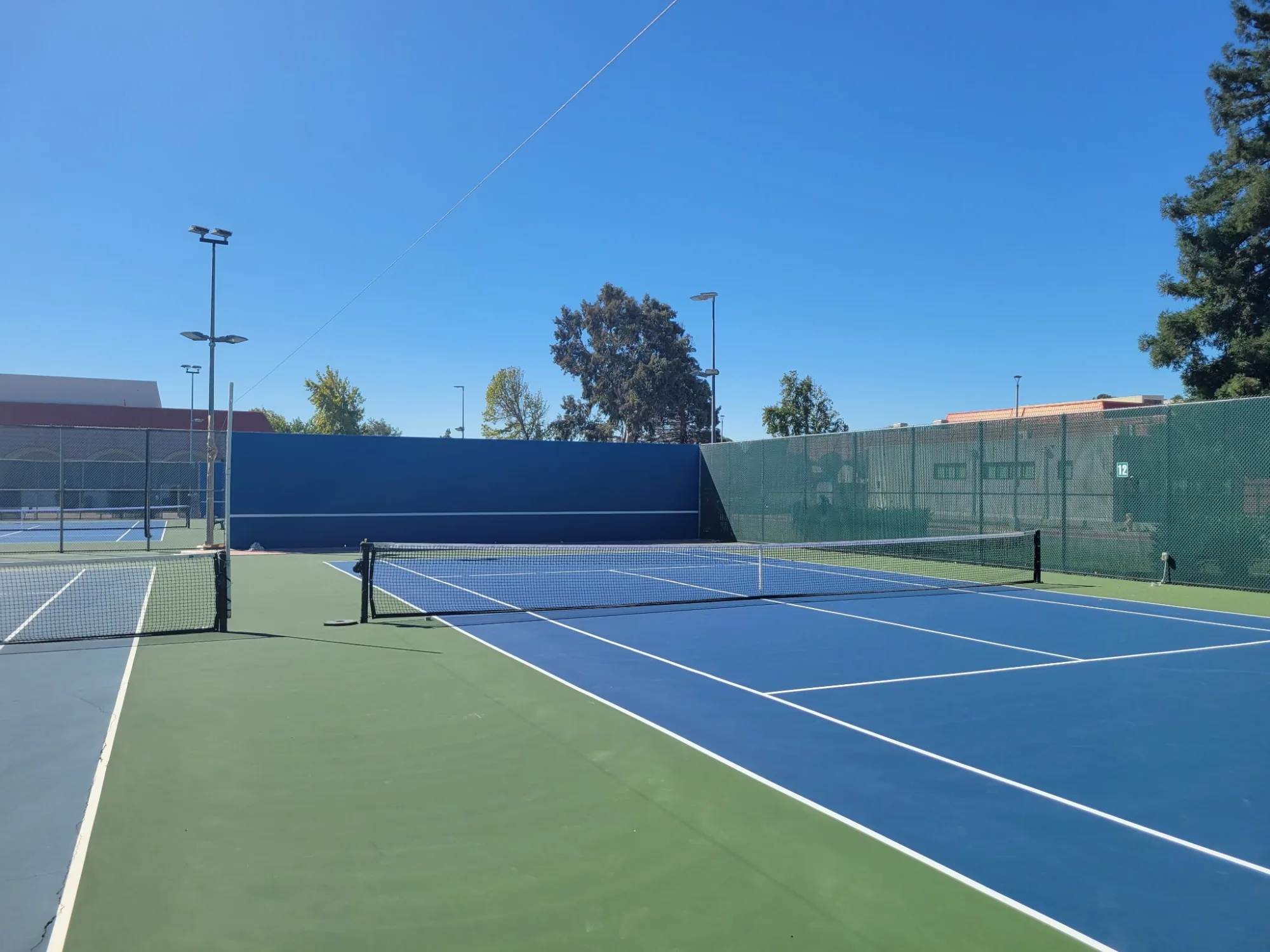 Pickleball and tennis court with fresh line striping and color coating